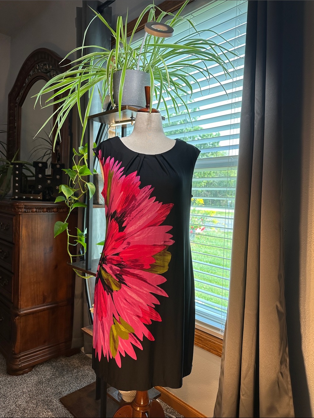Black Sleeveless Dress with Bold Pink Floral Accent